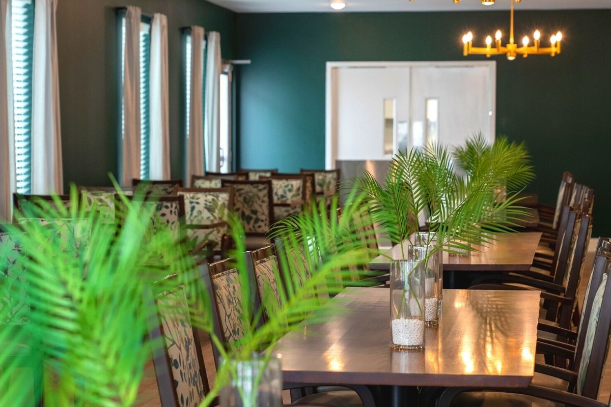 Dining tables with fern leaves as a centerpiece